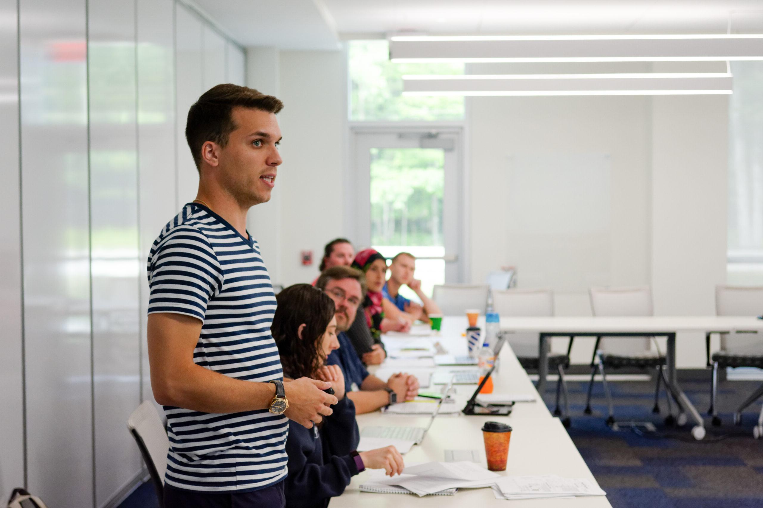 A student presenting during a DeVos Simulation event